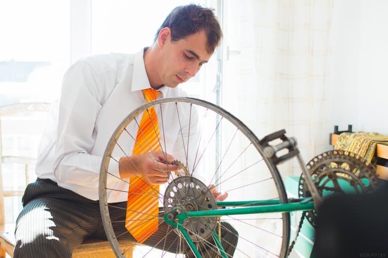 bicycle repair by man in apartment