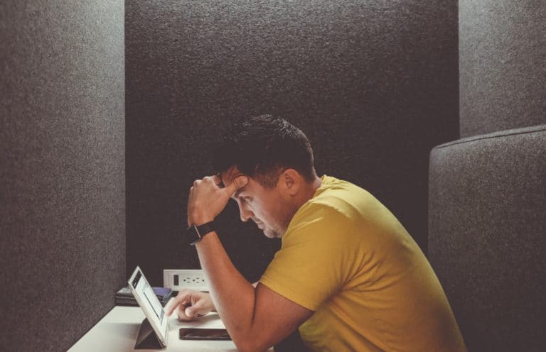 ergonomics at work - man slumped over desk