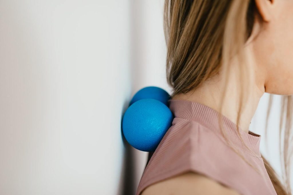 Close up photo of a woman pressing her neck on a stress ball